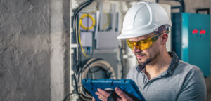 Technician using a Resco app on tablet to complete a digital hazard assessment checklist.